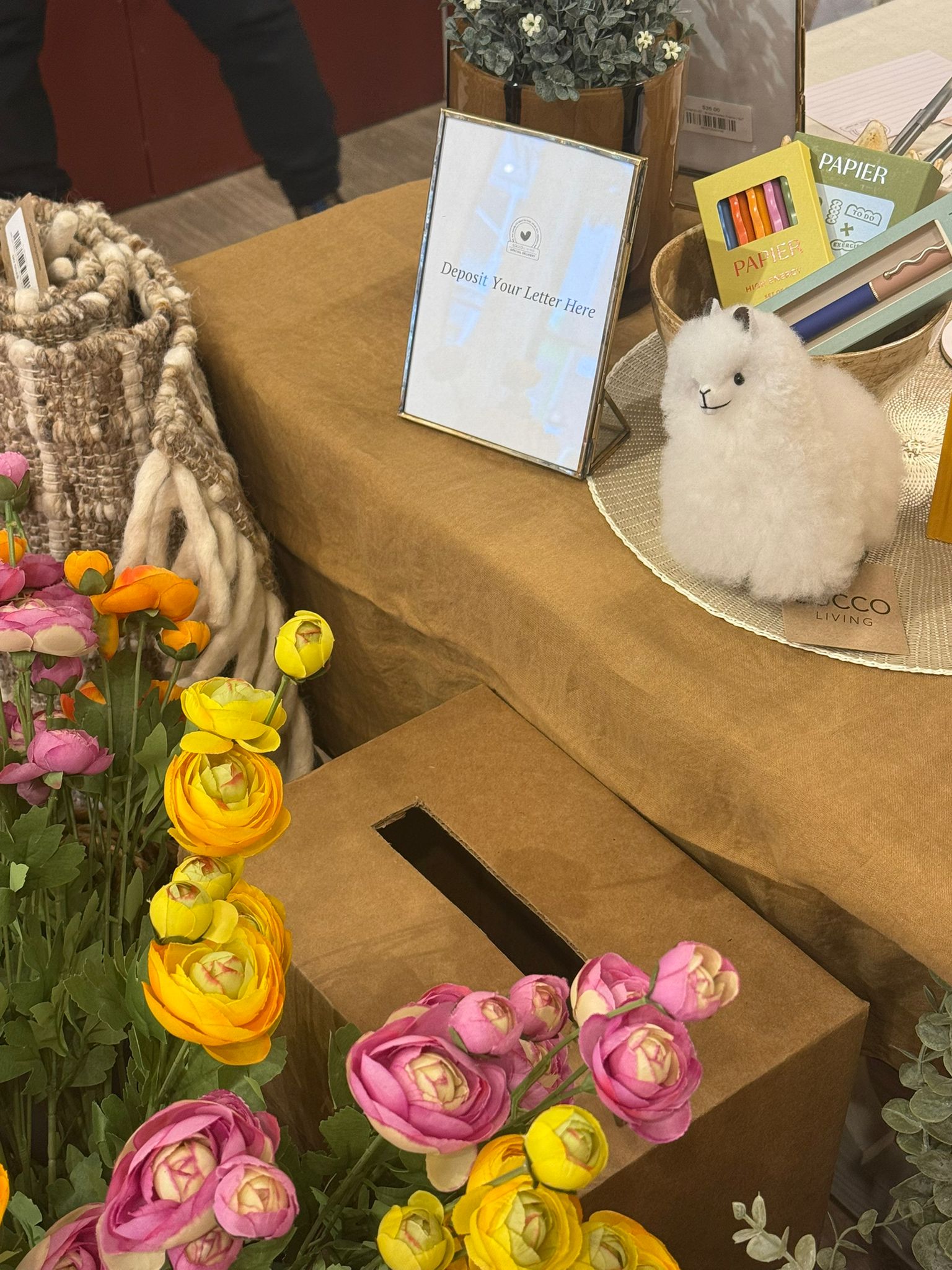 Flowers and a letter collection box at the SOCCO and Neso Wellness pop-up